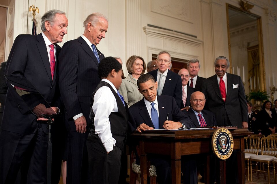 President Obama signs a health-care bill, March 2010.